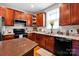 This kitchen features wood cabinets, granite countertops, stainless appliances and a kitchen island at 14940 Carbert Ln, Huntersville, NC 28078