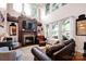 Spacious living room with a stone fireplace, high ceilings, and ample natural light at 14940 Carbert Ln, Huntersville, NC 28078