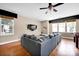 Inviting living room with hardwood floors, neutral walls, ceiling fan, and a comfortable gray sectional at 14940 Carbert Ln, Huntersville, NC 28078