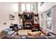 Bright living room with fireplace, built-in shelving, and large windows at 14940 Carbert Ln, Huntersville, NC 28078