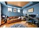 Comfortable living area featuring a sofa, desk, guitar, and stylish decor at 14940 Carbert Ln, Huntersville, NC 28078