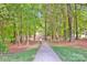 Picturesque pathway through lush greenery, inviting for leisurely strolls amidst the serene wooded surroundings at 14940 Carbert Ln, Huntersville, NC 28078