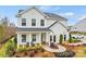 Charming new construction home boasts modern farmhouse design, inviting front porch, and professionally landscaped yard at 15008 Meadows Hunt Ln # 156, Huntersville, NC 28078