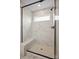 Beautiful bathroom with a glass-enclosed shower featuring marble tiling and a built-in seat at 15008 Meadows Hunt Ln # 156, Huntersville, NC 28078
