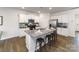 Modern kitchen with granite countertops, stainless steel appliances, and a large island with barstool seating at 151 Rustling Waters Dr, Mooresville, NC 28117