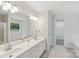 Bright bathroom with dual sinks, a large mirror, and a separate tub and shower at 15108 Castlebridge Ln, Matthews, NC 28104