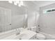 Clean bathroom featuring a sink, toilet, bathtub, and shower at 15108 Castlebridge Ln, Matthews, NC 28104