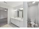Bathroom with double vanity sink and tile flooring and a separate toilet room at 15108 Castlebridge Ln, Matthews, NC 28104