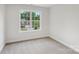 Carpeted bedroom showcasing a large window providing natural light at 15108 Castlebridge Ln, Matthews, NC 28104