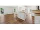 Spacious living area with hardwood flooring and a seamless transition to the kitchen with granite countertops at 15108 Castlebridge Ln, Matthews, NC 28104