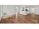 Spacious living area with hardwood flooring and a seamless transition to the kitchen at 15108 Castlebridge Ln, Matthews, NC 28104
