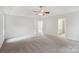 Large main bedroom with plush carpet, a ceiling fan, and natural light at 15108 Castlebridge Ln, Matthews, NC 28104