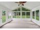 Sunroom with vaulted ceilings and multiple windows with natural lighting at 15108 Castlebridge Ln, Matthews, NC 28104