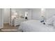 Cozy bedroom featuring a white comforter, soft lighting, and views into the hallway and bathroom at 155 Rustling Waters Dr, Mooresville, NC 28117