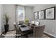 Elegant dining room with a table set for six, enhanced by natural light and stylish decor at 155 Rustling Waters Dr, Mooresville, NC 28117
