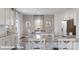 Spacious kitchen features white cabinetry, granite countertops, and an inviting dining area at 155 Rustling Waters Dr, Mooresville, NC 28117