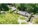 Beautiful aerial view of a home with a lush, green lawn, mature trees, and long driveway at 1602 Brentwood Dr, Newton, NC 28658