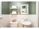 Charming bathroom with decorative mirror, stylish pedestal sink, and tiled floors at 1602 Brentwood Dr, Newton, NC 28658
