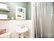 Bright bathroom with pedestal sink and a shower with glass doors at 1602 Brentwood Dr, Newton, NC 28658