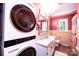 This bathroom features a stackable washer and dryer, a large mirror, and plenty of counter space at 1602 Brentwood Dr, Newton, NC 28658