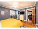 This bedroom features a ceiling fan, hardwood floors, a view of the bathroom, and ample storage space at 1602 Brentwood Dr, Newton, NC 28658