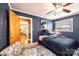 This blue bedroom features a ceiling fan, hardwood floors, and a view of the Primary bedroom at 1602 Brentwood Dr, Newton, NC 28658