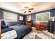 This sunny bedroom has two windows, a ceiling fan, and an area rug at 1602 Brentwood Dr, Newton, NC 28658