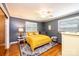 This bright bedroom features hardwood floors, neutral walls, two windows, and a ceiling fan at 1602 Brentwood Dr, Newton, NC 28658