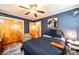 This comfortable bedroom has blue walls, an area rug, a ceiling fan, and a closet for storage at 1602 Brentwood Dr, Newton, NC 28658