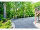 Driveway featuring a mix of asphalt and stone, surrounded by greenery at 1602 Brentwood Dr, Newton, NC 28658