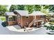 Exterior view of the home with deck, stone landscaping, screened porch, and brick facade at 1602 Brentwood Dr, Newton, NC 28658