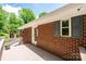The exterior of the home features brick, updated windows, a fenced-in yard, and a wooden deck perfect for entertaining at 1602 Brentwood Dr, Newton, NC 28658