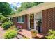 Charming front porch with brick accents and colorful flower pots at 1602 Brentwood Dr, Newton, NC 28658