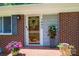 Charming front porch featuring brick accents and colorful flower pots at 1602 Brentwood Dr, Newton, NC 28658