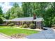 Charming brick home with lush landscaping, a screened porch, and a well-manicured front yard at 1602 Brentwood Dr, Newton, NC 28658
