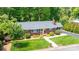 Aerial view of a brick home featuring a charming front yard with mature trees at 1602 Brentwood Dr, Newton, NC 28658