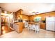 Classic kitchen with wooden cabinets, a kitchen island with stools, and a ceiling fan at 1602 Brentwood Dr, Newton, NC 28658