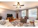 Bright living room with large windows, hardwood floors, and a comfortable leather armchair at 1602 Brentwood Dr, Newton, NC 28658