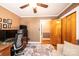 This cozy office features wood trim, a ceiling fan, and a large built-in desk for all your work from home needs at 1602 Brentwood Dr, Newton, NC 28658