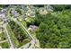 Stunning aerial view of a luxury home nestled in a lush, wooded neighborhood with mature trees and landscaping at 17416 Gillican Overlook Rd, Davidson, NC 28036