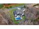 Aerial shot of a luxurious home with a pool, meticulously manicured lawn, and mature trees at 17416 Gillican Overlook Rd, Davidson, NC 28036