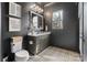 Stylish bathroom with dark walls, patterned floor tiles and modern fixtures at 17416 Gillican Overlook Rd, Davidson, NC 28036