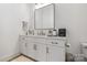 Clean bathroom with white vanity, modern mirror and neutral decor at 17416 Gillican Overlook Rd, Davidson, NC 28036