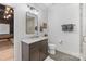 Clean bathroom with a modern vanity, decorative mirror, and well-organized towel racks, showcasing its functionality at 17416 Gillican Overlook Rd, Davidson, NC 28036