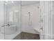 Luxurious bathroom featuring a glass enclosed shower with herringbone tile and soaking tub at 17416 Gillican Overlook Rd, Davidson, NC 28036
