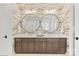 Modern bathroom featuring double vanity with marble countertop and round mirrors at 17416 Gillican Overlook Rd, Davidson, NC 28036
