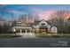 Beautiful front exterior with manicured landscaping and a three-car garage at 17416 Gillican Overlook Rd, Davidson, NC 28036