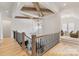 Elegant foyer featuring light wood floors, wood beams, and decorative lighting fixtures adding visual appeal and charm at 17416 Gillican Overlook Rd, Davidson, NC 28036