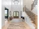 Bright foyer with high ceilings, hardwood floors and staircase with iron railing at 17416 Gillican Overlook Rd, Davidson, NC 28036