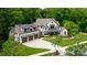 An immaculate exterior showcasing pristine landscaping, a three-car garage and architectural design at 17416 Gillican Overlook Rd, Davidson, NC 28036